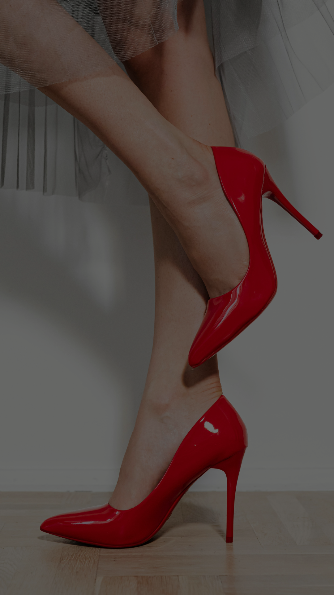 Person wearing red high heels and tulle skirt. Still Standing ® foot spray creates happy feet for stiletto and high heel lovers. Mobile Hero background for About page